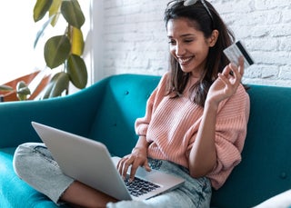 Girl smiling with credit card in her hand