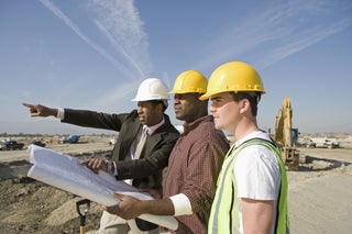 three men in yellow hard hats