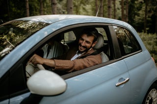 Man driving new blue car