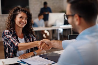 business woman shakes hands with banker