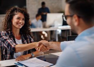 business woman shakes hands with banker