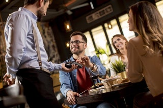 Man pays for meal at a restaurant