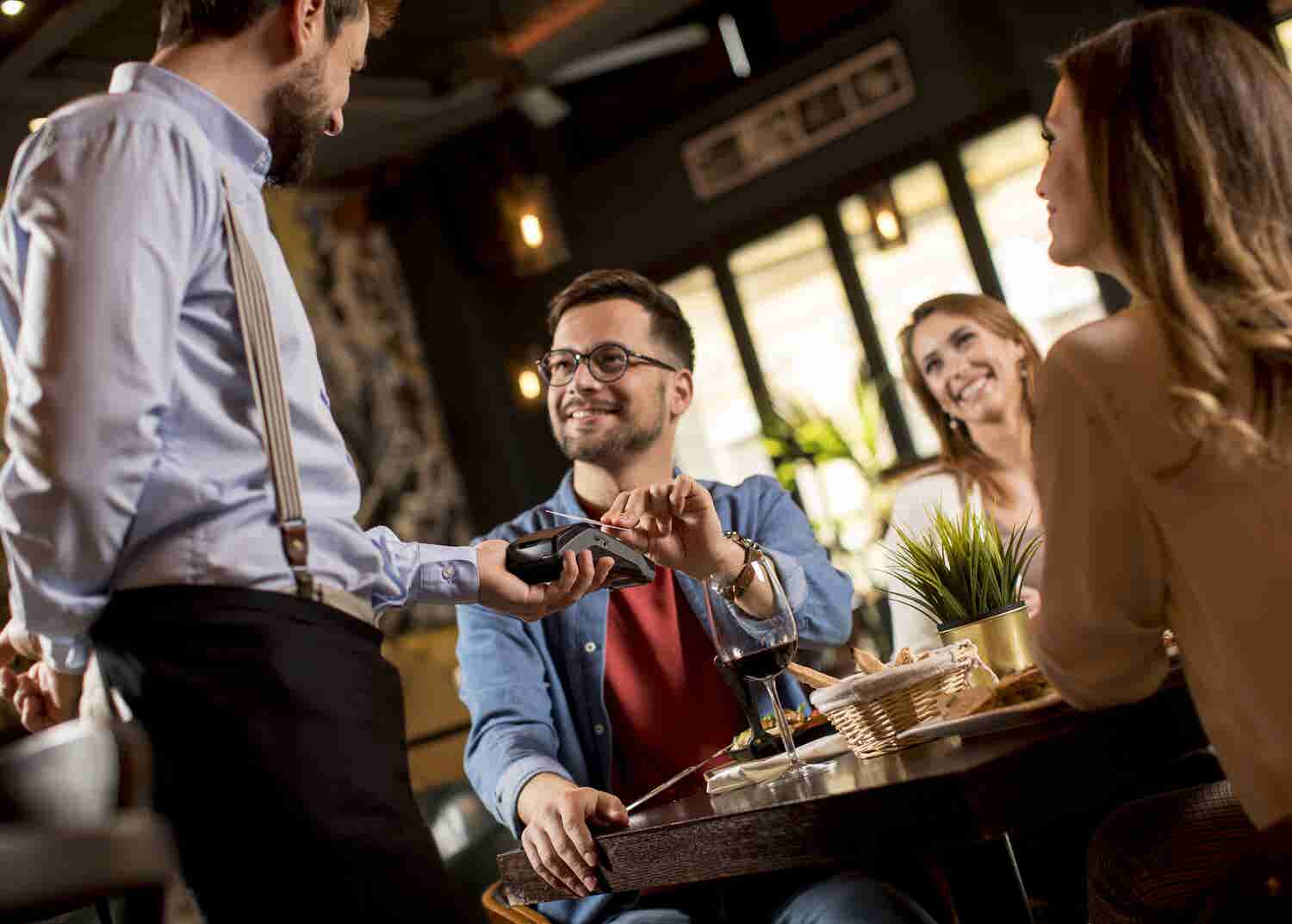 Man pays for meal at a restaurant