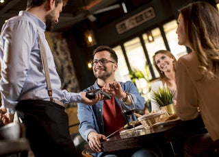 Man pays for meal at a restaurant