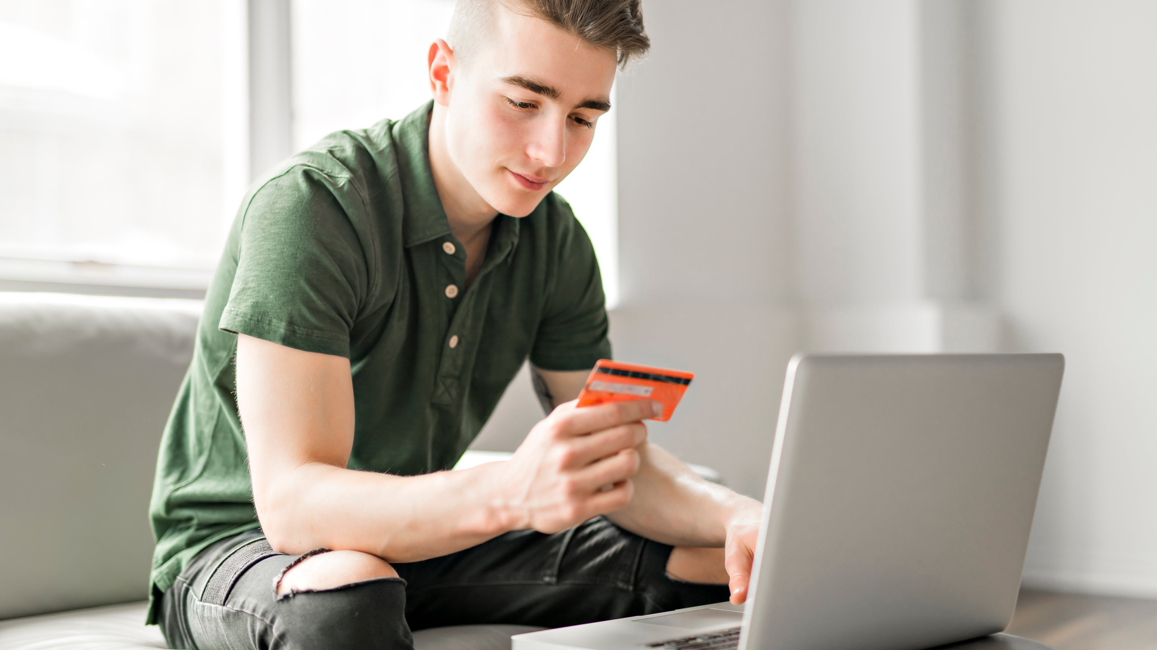 Boy uses credit card to shop online