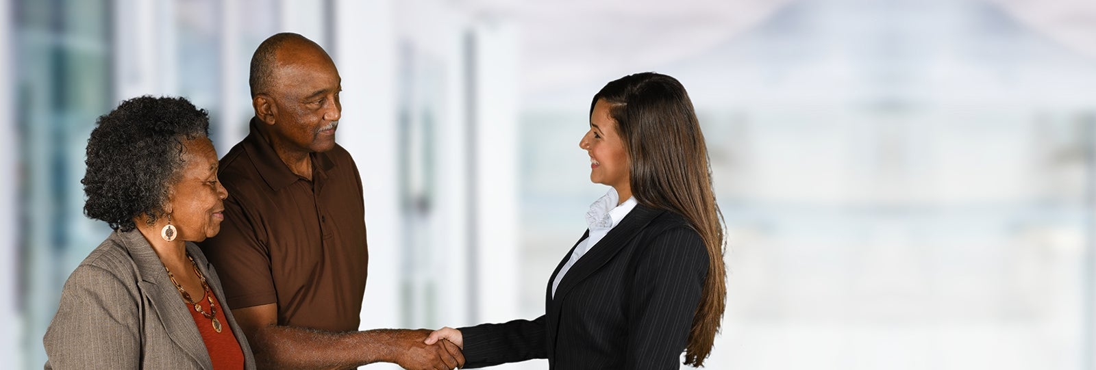 Couple shakes hand with advisor