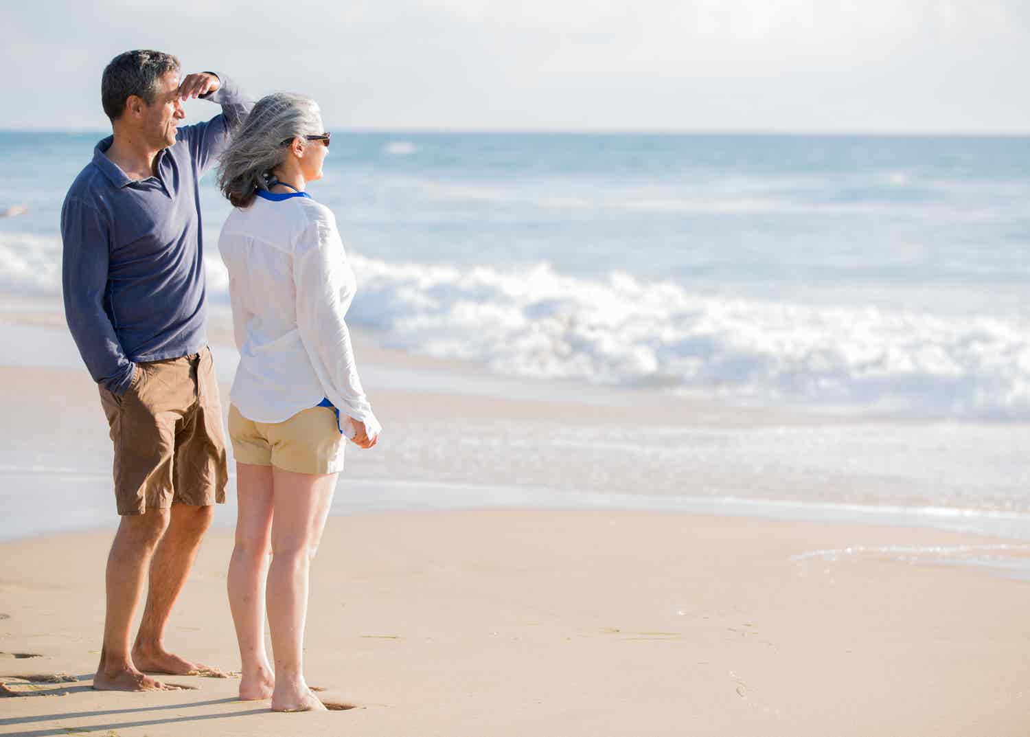 Couple on beach looking at water