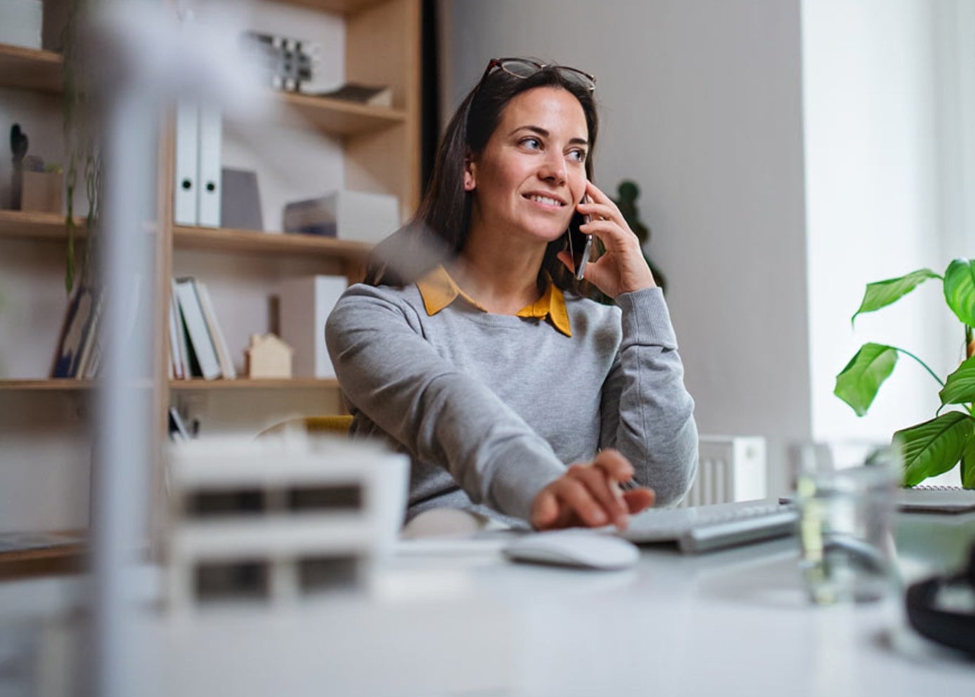 Woman sitting at desk on the phone