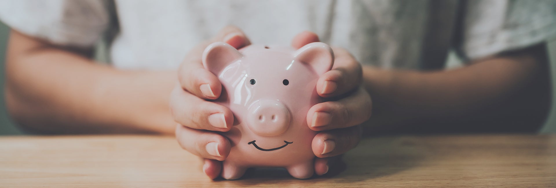 Hands holding a piggy bank