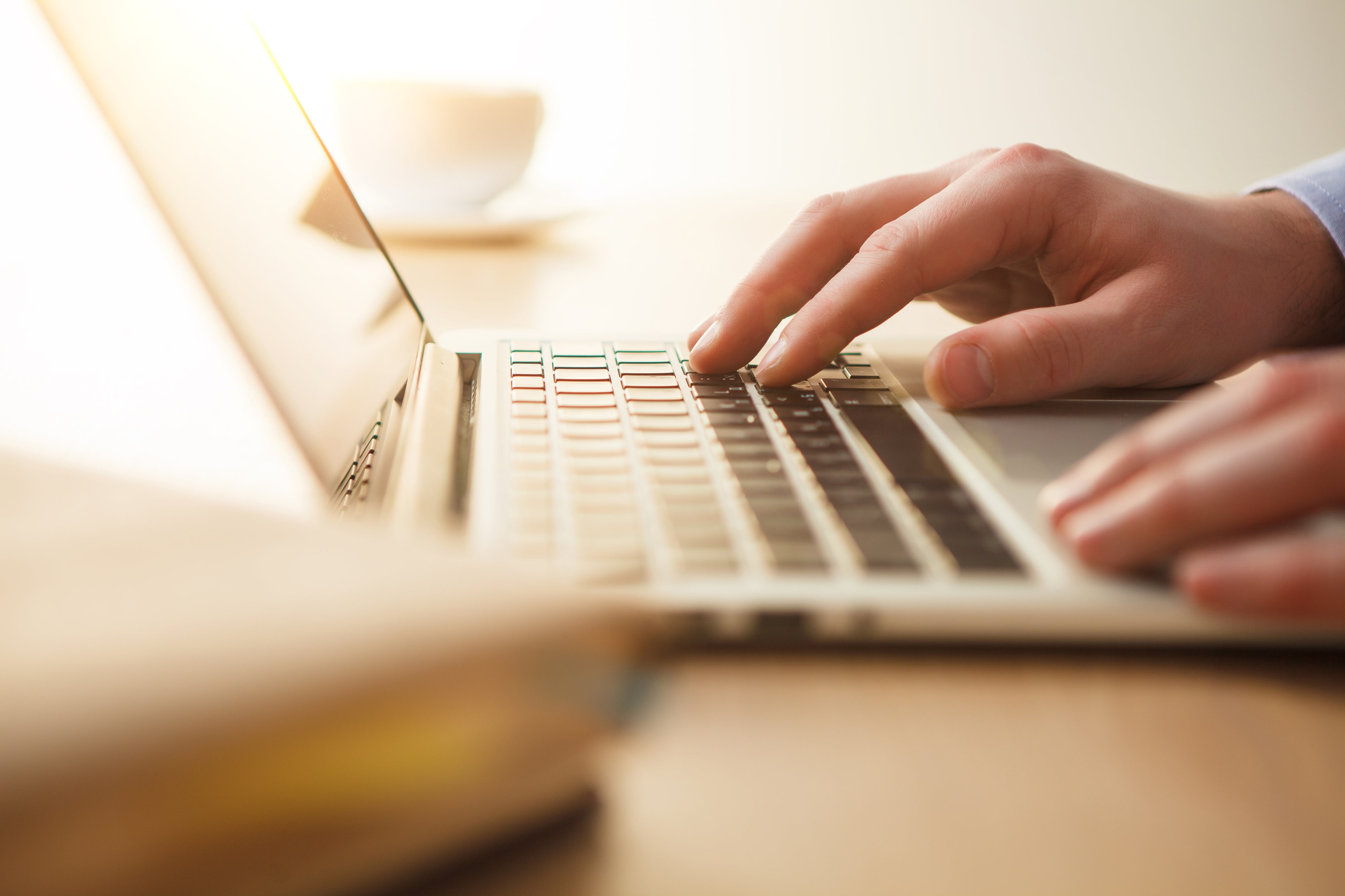 Hands typing on laptop computer