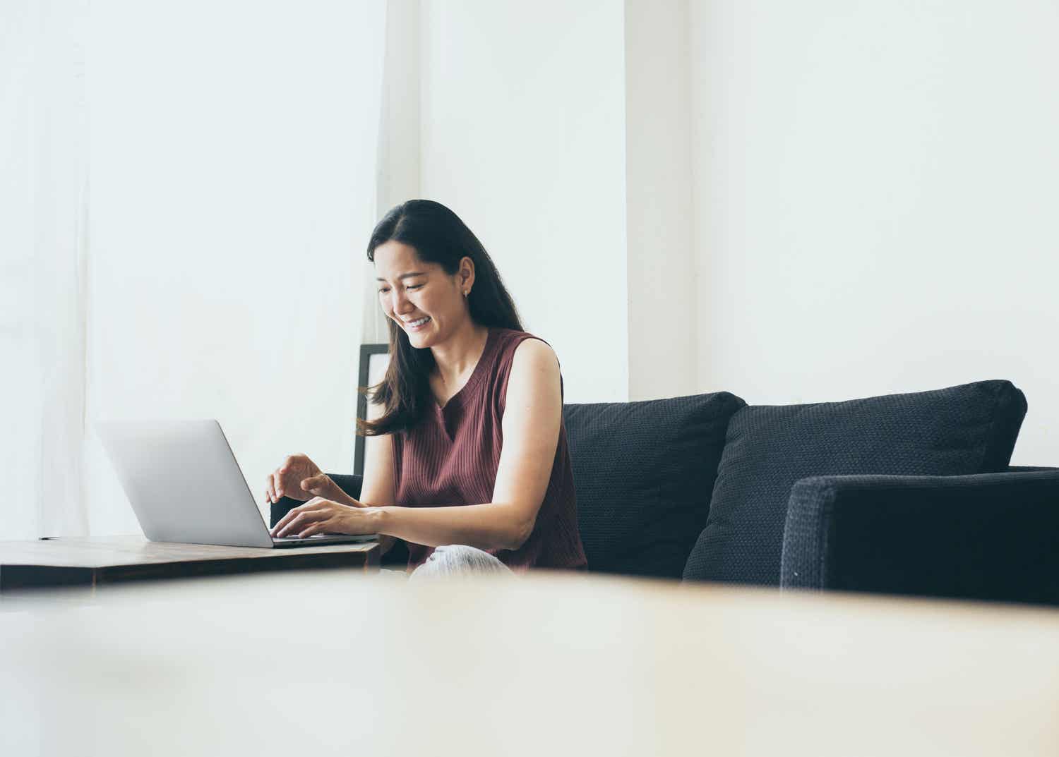 Woman smiling at laptop