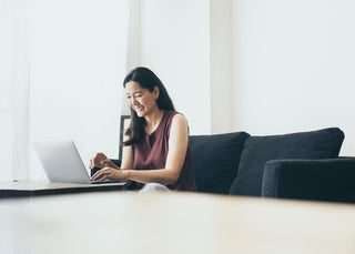 Woman smiling at laptop