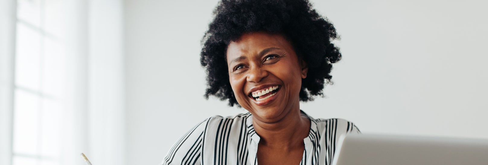 Happy woman smiling in striped shirt