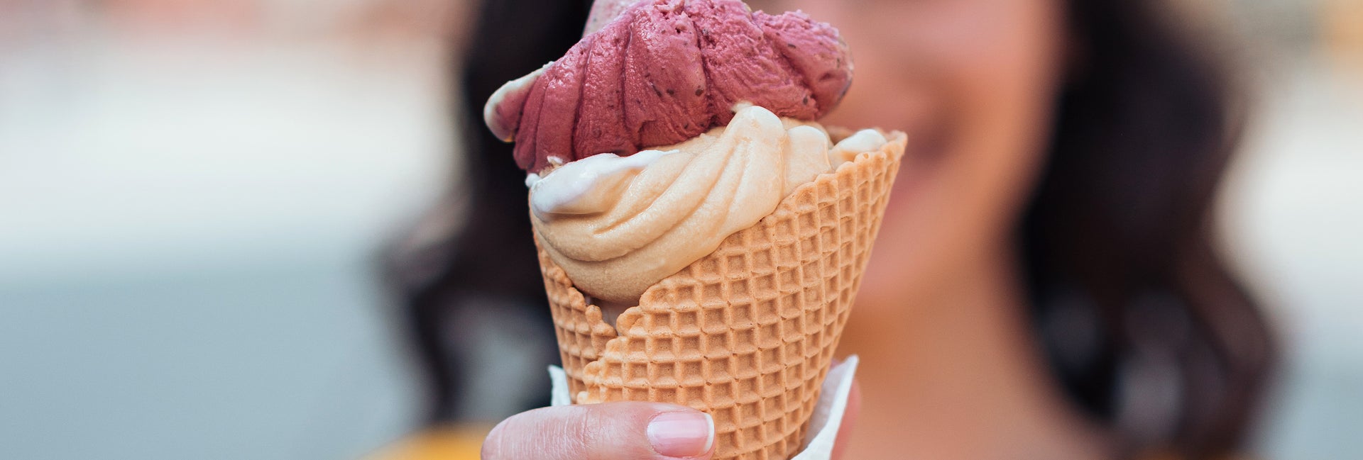 Woman holds out an ice cream cone