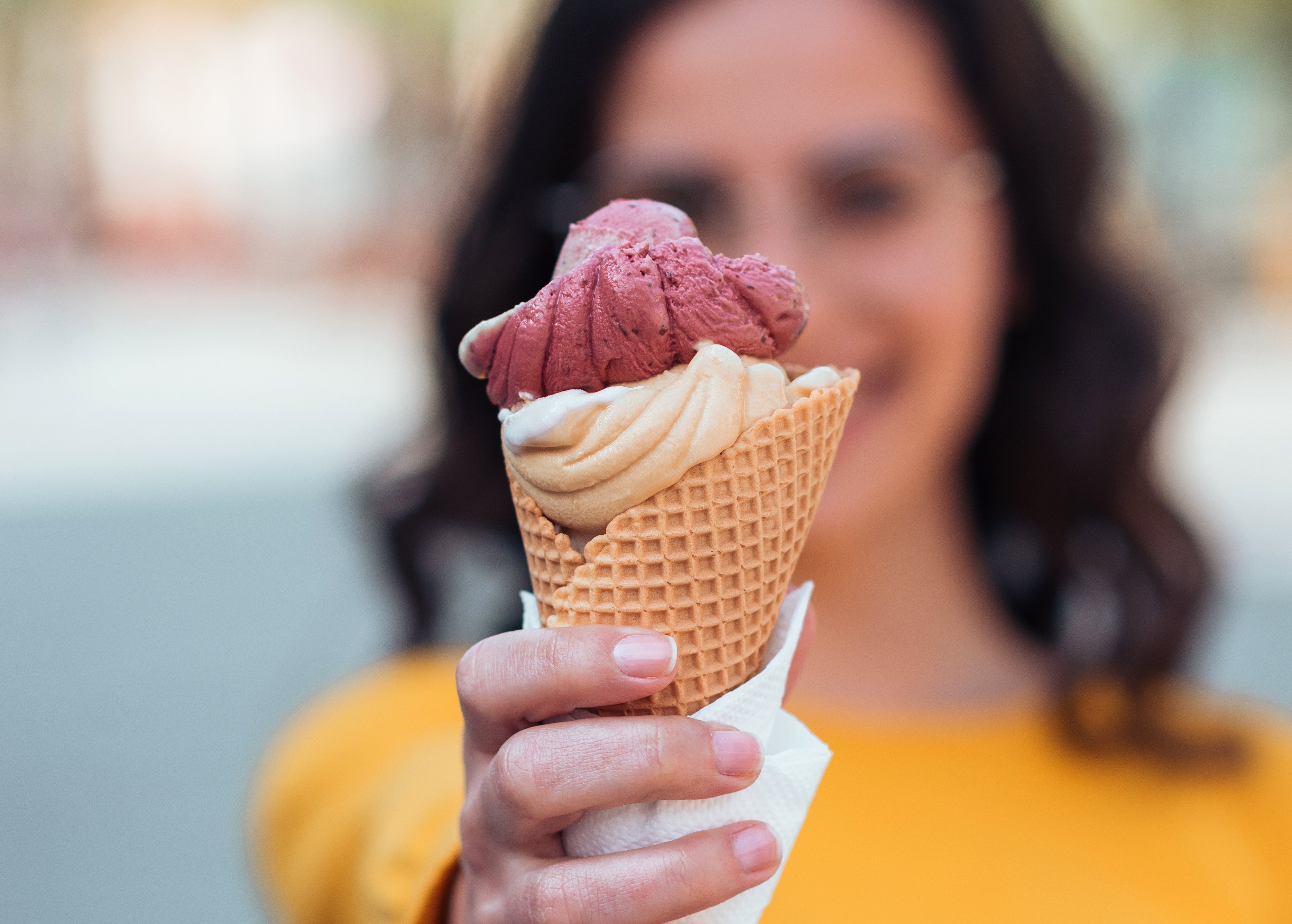 Woman holds out an ice cream cone