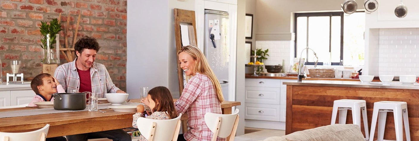 Family of four sits at dinner table