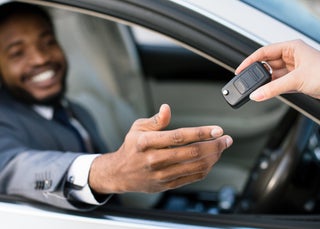 Man in car receiving new car key
