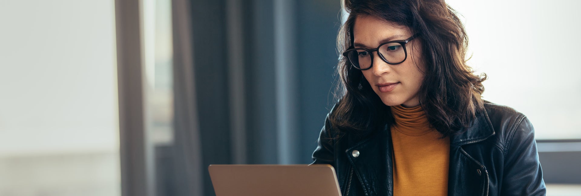 Woman looking at laptop