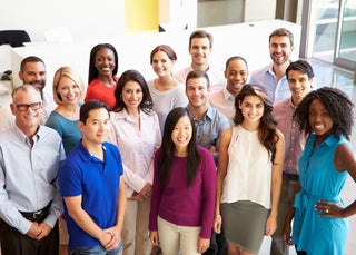 Employees smile together in a group photo