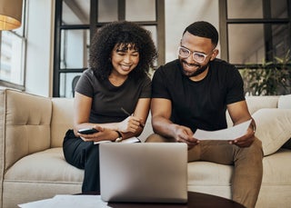 Couple looking over finances on laptop