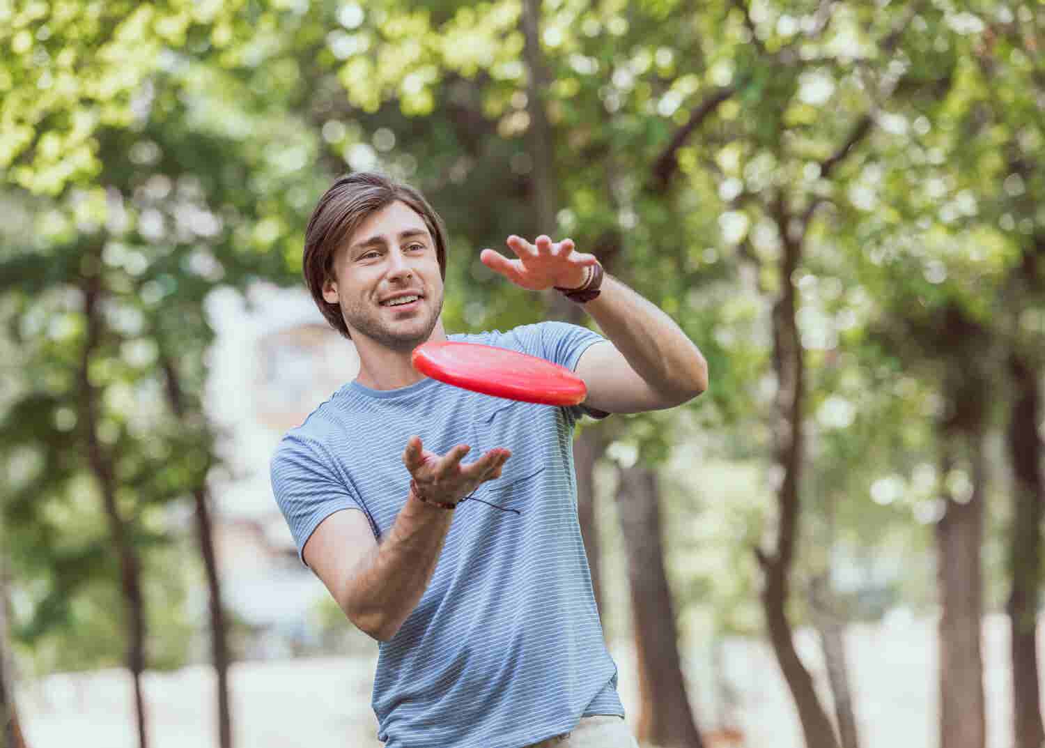 Man catches a frisbee with two hands