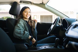 Teenage girl preparing to start her car and drive