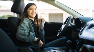 Teenage girl preparing to start her car and drive