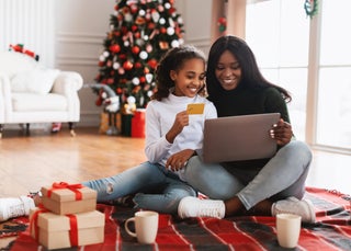 Mom and daughter shopping for the holidays with credit card