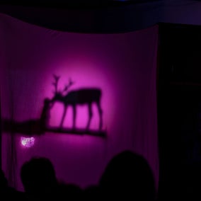 Shadow puppets showing Smolíček, a boy raised by deer with golden antlers