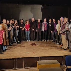 Sometimes it's hard to all fit onstage. Here, 17 actors circle around a small stage.