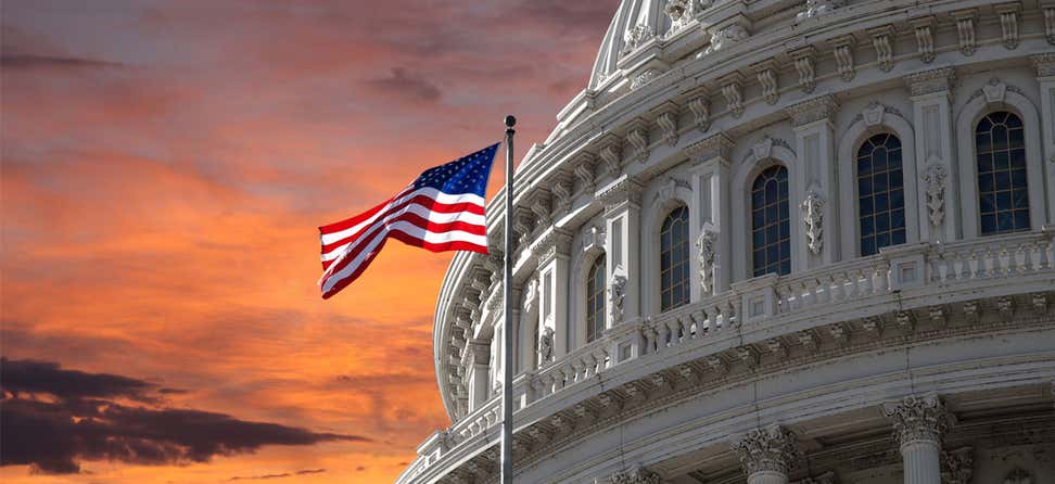 The sunset sky over the U.S. Capitol, the flag flying proudly.
