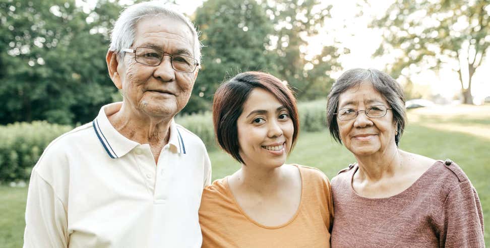 Older Asian couple with caregiver daughter