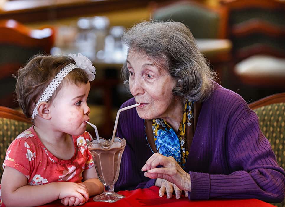 2019 second place winner for the annual NCOA Awards Photography Contest. Titled "Grandma Quality Time," a senior woman is sharing chocolate milkshake with her granddaughter.