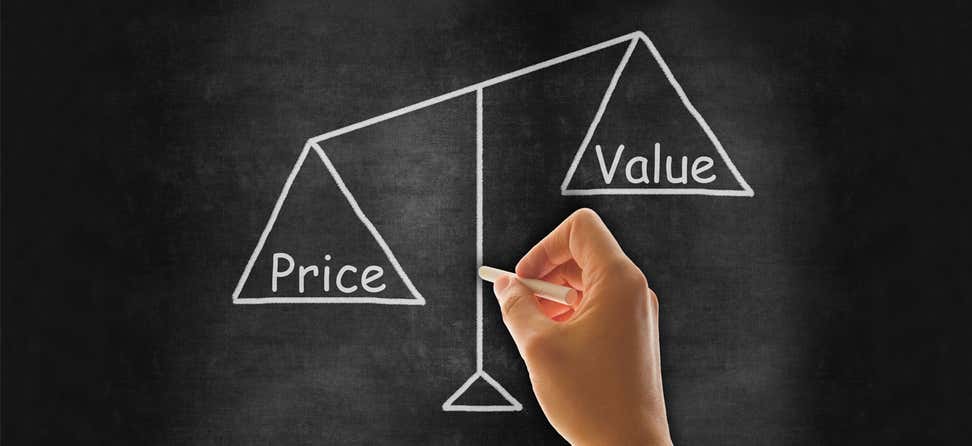A scale is shown written on a chalkboard, where the word "price" weighs heavier on the left than "value" on the right.
