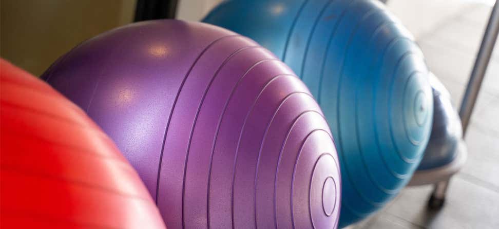 A closeup of three yoga exercise balls in a row.