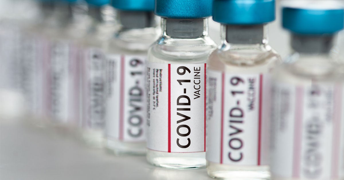 Up close shot of several COVID-19 vaccine vials placed in a row.