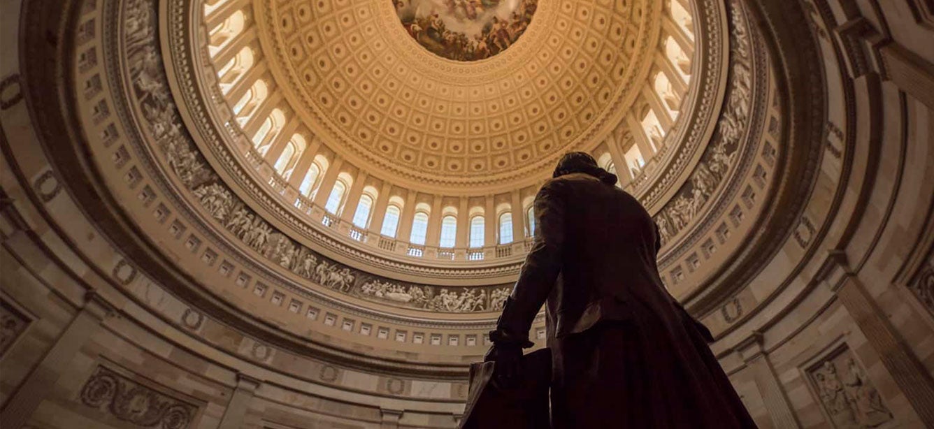 A close up view of the intricate detail of the U.S. Capitol Rotunda ceiling and silhouette of George Washington.