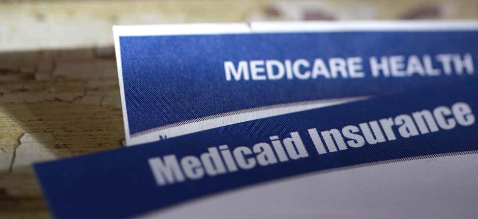 Up close image of Medicare and Medicaid health insurance cards.