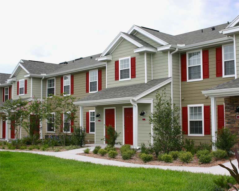 A street view of a row of new houses in a suburban neighborhood.