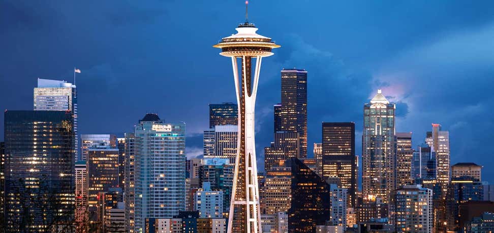 The Space Needle in Seattle takes front and center among a backdrop of the city.