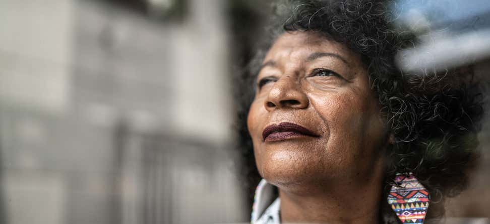 An up close shot of a Black senior woman, looking proud and determined to prevent osteoporosis. While Black women have a lower prevalence of osteoporosis overall, they experience worse outcomes after fractures caused by osteoporosis.