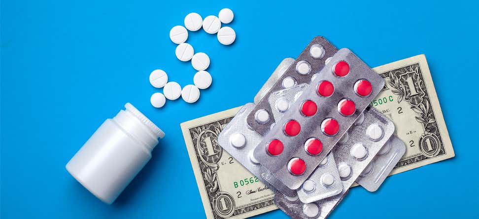 A close up shot of a prescription bottle, money, pills, demonstrating the high-cost of prescriptions.