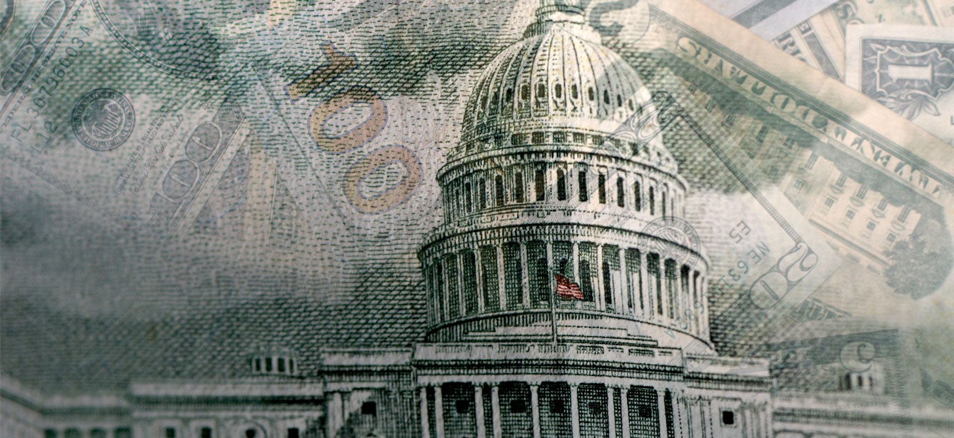 U.S. printed money overlays an external shot of the rotunda at the U.S. Capitol.